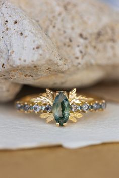 a close up of a ring with a stone in the middle and other stones around it