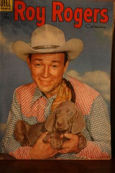 an old magazine with a man holding a puppy in his lap and wearing a cowboy hat