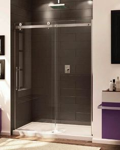 a bathroom with a walk in shower next to a white sink and purple rug on the floor