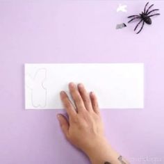 someone is making a spider out of paper