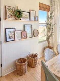 two wicker baskets sit on the wall in front of a window with pictures above it