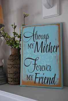 there is a sign that says always my mother forever my friend on the shelf next to some vases