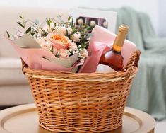 a wicker basket filled with flowers and wine