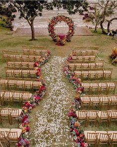 an overhead view of a wedding ceremony with flowers on the aisle and chairs lined up in rows