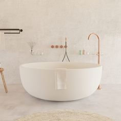 a large white bath tub sitting on top of a bathroom floor