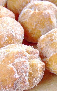 some sugared donuts are sitting on a table