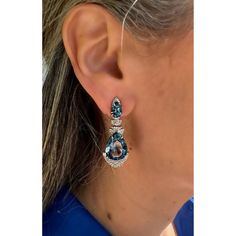 Delivery in 3-5 business days Need it faster? Text us at (619) 247.5731 or Call us at (619) 365.4736 ﻿This pair of earrings are perfect for special occasions, this design gives the piece an elegant touch. Diamond: 2.11 ct Blue London Topaz: 30.690 ct Rhodium Plated Silver: 6.56 grams 14K Yellow Gold Post: 0.18 grams