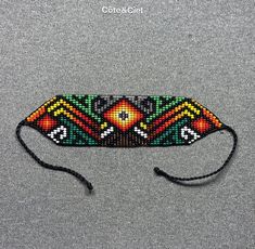 This beautiful beaded bracelet is hand-woven by the women of the Embera Chami Indigenous Tribe of Colombia Bohemian Black Beads Friendship Bracelets, Bohemian Friendship Bracelets With Black Beads, Bohemian Black Handwoven Beaded Bracelets, Artisan Black Beaded Bracelets For Festivals, Traditional Woven Beaded Bracelets For Beach, Traditional Multicolor Woven Beaded Bracelets, Black Woven Beaded Bracelets For Festival, Traditional Green Friendship Bracelets, Black Bohemian Handwoven Bracelet