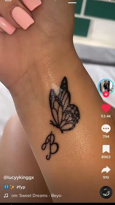 a woman's wrist with a butterfly tattoo on the left side of her arm