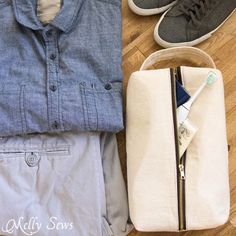 clothes laid out on the floor next to a pair of shoes and an empty wallet