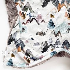 an image of a blanket with mountains on it