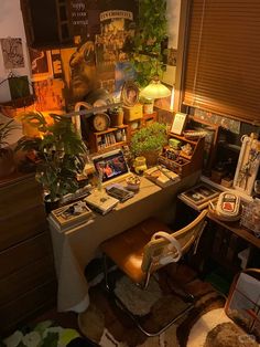 a desk with many plants and pictures on it