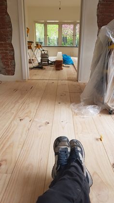 a person's feet in the middle of an unfinished room