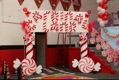 an entrance decorated with candy canes and balloons for a school birthday party or celebration