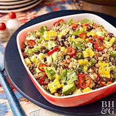 a bowl filled with rice and vegetables on top of a blue plate