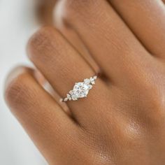 a woman's hand with a diamond ring on it