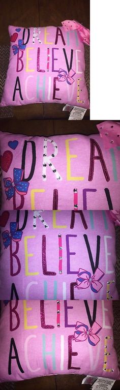 three pink pillows with different designs on them