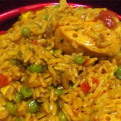 a red plate topped with rice and peas