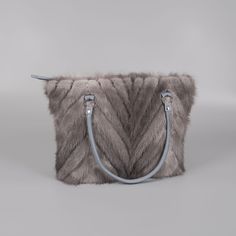 Elevate your accessory game with this luxurious gray tote bag, expertly crafted from authentic mink fur. Its plush texture and superior-quality materials make it a must-have for anyone seeking to infuse luxury into their daily style. Ideal for everyday essentials or standout pieces for special events, the bag boasts a generous interior space thoughtfully designed to hold all your items. With its refined construction and keen attention to detail, this tote bag is versatile enough to enhance a for Luxury Bags With Faux Fur Lining For Everyday Use, Rectangular Faux Fur Shoulder Bag For Everyday Use, Everyday Rectangular Faux Fur Shoulder Bag, Rectangular Faux Fur Bag For Daily Use, Luxury Faux Fur Bag For Everyday Use, Luxury Faux Fur Bags For Everyday Use, Rectangular Faux Fur Bag With Fur Lining, Daily Use Faux Fur Shoulder Bag, Rectangular Faux Fur Shoulder Bag With Fur Lining