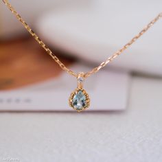 Embrace the serene beauty of our Teardrop Aquamarine Necklace, featuring a tiny aquamarine pendant. This elegant blue stone necklace showcases a teardrop-shaped aquamarine, a gemstone known for its calming energy and clarity. As the birthstone for March, aquamarine is a perfect gift for those born in this month. This necklace is a versatile accessory, ideal for both everyday wear and special occasions. Whether you're celebrating a March baby or looking for a thoughtful gift for her, this necklac Elegant Light Blue Round Pendant Necklace, Blue Aquamarine Briolette Necklace, Light Blue Aquamarine Gemstone Necklace, Elegant Light Blue Necklaces For Gifts, Fine Jewelry Aquamarine Light Blue Necklace, Fine Jewelry Light Blue Aquamarine Necklace, Light Blue Aquamarine Necklace Fine Jewelry, Fine Jewelry Light Blue Gemstone Necklace, Sapphire Drop Necklaces For Gifts