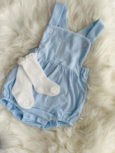 Perfect for those hot summer days. The sunsuit has white piping around the bib of the sun suit, elastic around the back of the waist, cross-straps in back with buttons in front, and elastic at the legs. Spring Playtime White Overalls, White Overalls For Playtime In Spring, White Overalls For Spring Playtime, Cotton Bubble Romper For Baptism In Summer, Cute Bib Front Overalls For Summer, White Onesie For Baptism In Summer, White Summer Onesie For Baptism, Summer Bib Front Jumpsuits And Rompers For Playtime, Summer Jumpsuits And Rompers With Bib Front