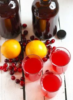 two glasses of cranberry juice and three bottles of orange juice