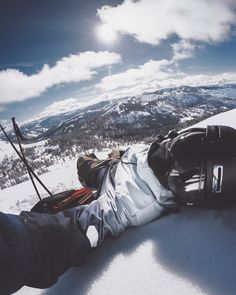 a person laying on the snow with their feet up