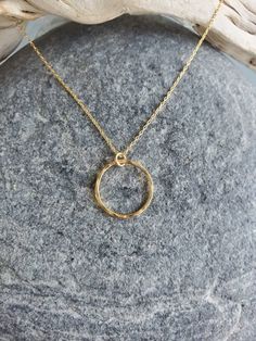 "This beautiful necklace has a handmade tiny gold circle. Perfect to wear every day. The circle measures 10mm across and it hangs on a 14K gold filled chain with a 14K gold filled clasp. Shown in 18\" length, but can be made as a long layering necklace also. Please choose length above. Also available in silver as shown in the last photo. *If you are unsure of the length you need, or would like to wear this item at different lengths, we now offer an adjustable length option! You can add an adjust Gold Circle Charm Necklace In Sterling Silver, Gold Circle Minimalist Charm Necklace, Minimalist Circle Charm Gold Necklace, Minimalist Gold Circle Charm Necklace, Everyday Yellow Gold Circle Charm Necklace, Delicate Round Charm Necklace For Everyday, Circle Shaped Yellow Gold Charm Necklace For Gift, Circle Charm Necklace In Yellow Gold For Gift, Dainty Round Gold-plated Charm Necklaces