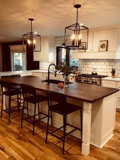 the kitchen is clean and ready to be used for cooking or dining room furniture, as well as an island with stools