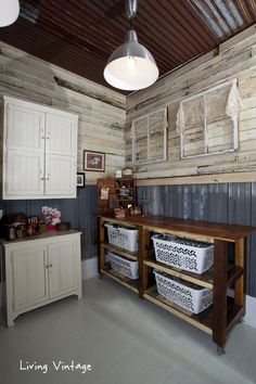 a kitchen with white cabinets and baskets on the counter