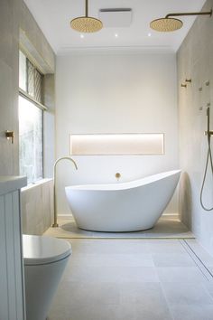 a large white bathtub sitting in the middle of a bathroom