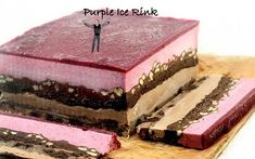 a piece of cake that is on top of a cutting board with the words purple ice rink