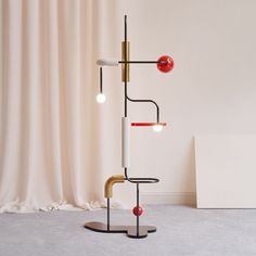 a lamp with three different colored lights on it's sides and one red light in the middle