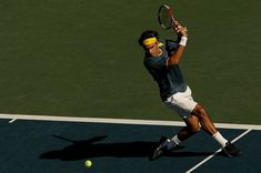 a male tennis player in action on the court