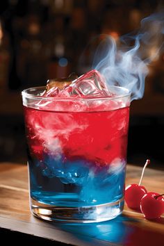 a red, white and blue drink sitting on top of a wooden table