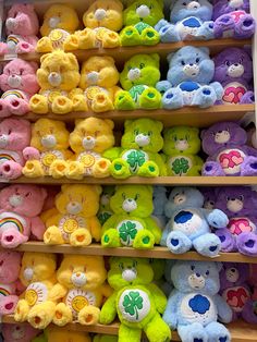 many different colored teddy bears are on display in a toy store with rainbows and shamrocks