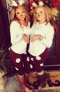 two women dressed up as mickey and minnie mouse ears, standing in front of a door