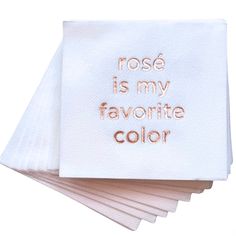 four white napkins with rose is my favorite color embroidered on them, sitting next to each other