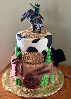 a birthday cake with a cowboy on top