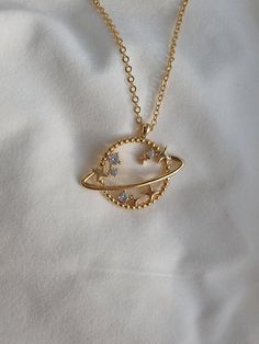 "PRODUCT INFORMATION MATERIALS : BRASS , 18K GOLD PLATED, LENGTH CHARM : CHAIN : 40 cm / 15.7 in , 45 cm / 17.7 in , 50 cm / 19.6 in SATURN PLANET NECKLACE YOU MAY ALSO LIKE THESE: HOW TO ORDER FROM US ? 1. Click on \"View cart and check out\" 2. At checkout, please fill in your special requests, check if the order is a gift. 3. Choose your shipping method. 4. Enter your payment details and complete purchase. MAINTENANCE OF YOUR JEWELRY - Maintain your jewelry's high shine by avoiding contact wi Cute Aesthetic Necklace, Moon And Saturn Necklace, Aesthetic Chains Necklace, Gold Necklace Aesthetic, Cute Gold Necklace, Cute Jewelry Necklaces, Necklaces Aesthetic, Gold Dainty Necklace, قلادات متدلية