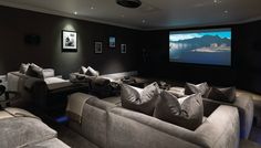 a large living room with couches and a projector in the middle of it