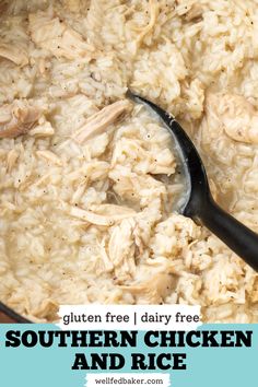 A spoon scooping a serving of chicken and rice from a large pot.