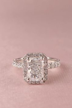 a cushion cut diamond ring set with pave diamonds