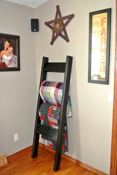 a room with a ladder and pictures on the wall