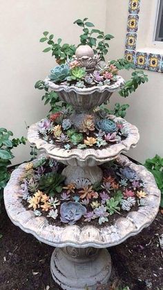 three tiered garden fountain with succulents and plants