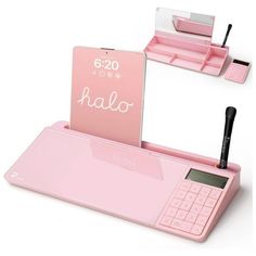 a pink calculator sitting on top of a desk next to a pen holder