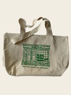 Inspired by our favorite bookstore in Sunshine Falls. Two-sided large zippered tote with Goode Books logo on the one side and the shop design on the other. Bottom Width: 16.5 inDepth 12.5 inStrap Length 24 in