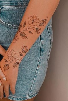 a woman with a flower tattoo on her arm