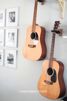 two guitars are hanging on the wall