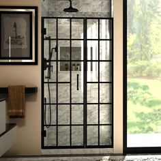 a glass shower door in a bathroom with tile flooring and black trim on the walls